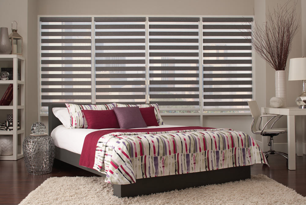 four large dark gray Allure® Transitional Shades behind a bed with dark red, white, and purple Interior Masterpieces® Custom Bedding