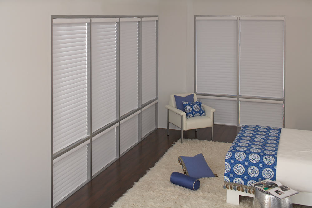 several large white Tenera® Sheer Shades & blue and white Interior Masterpieces® Custom Pillows and Bedding