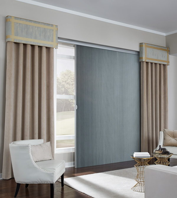 large blue Parasol® Glissade with tan Interior Masterpieces® draperies and brown and blue custom cornices at each end in